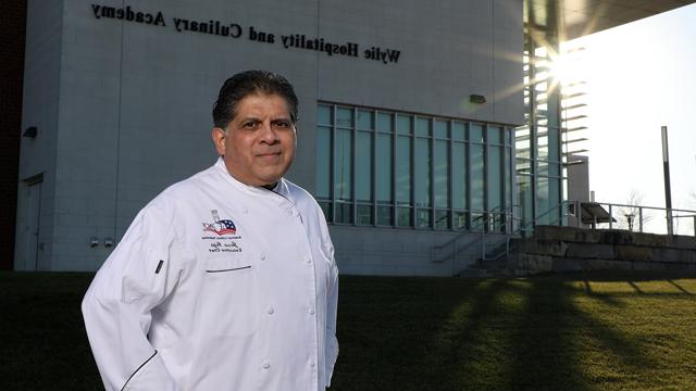 Jesse Vega standing outside the Wylie Hospitality and Culinary Academy